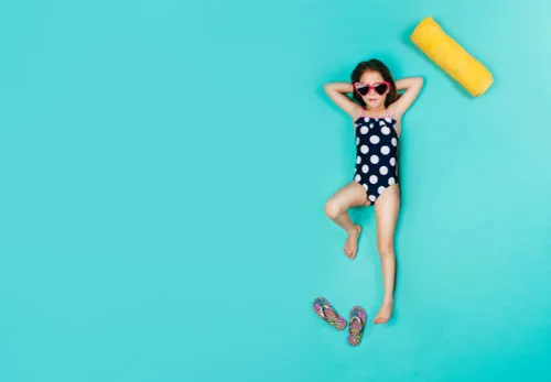 Cute girl imagining sunbathing on vacation